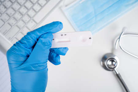 Coronavirus antibody home test kit. Medical holding a rapid testing kits.の写真素材