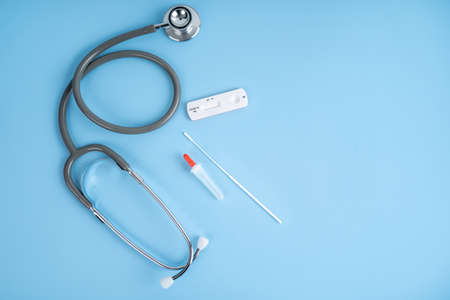 Medical stethoscope and Rapid antigen test Rapid Strep Test RST kit. Top view.の写真素材