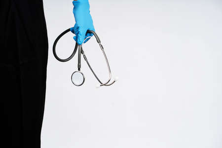 Close-up of a doctor holding a medical stethoscope in the studio.の写真素材