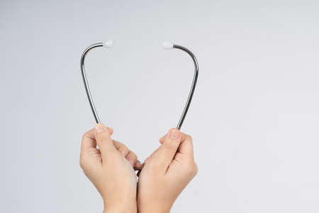 Medical background with hands holding a stethoscope.