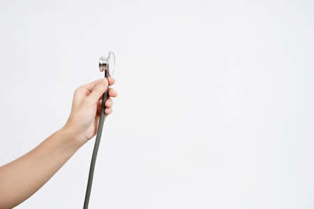 Woman doctor with a stethoscope in the hands.の写真素材