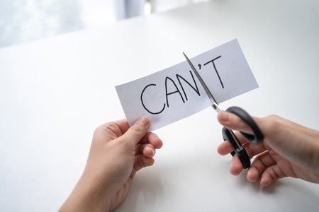 Motivation. I can do it. Hand using scissors to remove the word can't to read.の写真素材