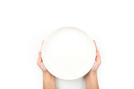 Hands holding a dish ceramic isolated on white backgroundの写真素材