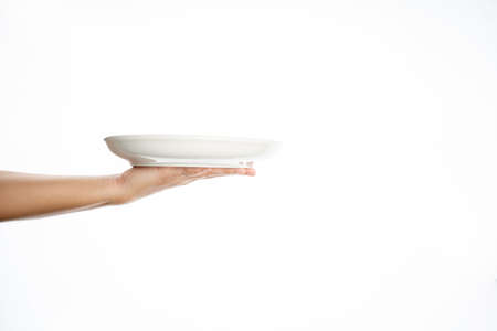 white kitchen plate on hand on white background, mock upの写真素材