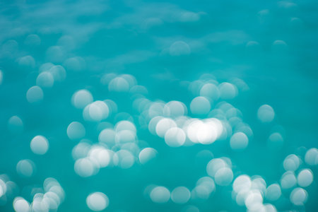 Water bokeh in the pool. Water surface in motion blur with bokeh lights from sunriseの写真素材