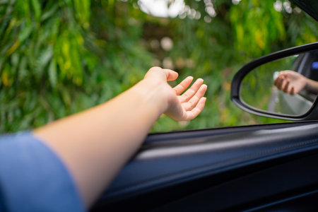 Happy young woman enjoys a leisurely vacation in the car.の写真素材
