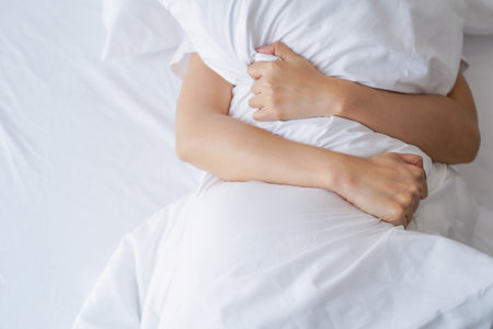 Top view of  young sexy womandoing sign orgasm on white bed. sex and erotic concept for advertisementの写真素材