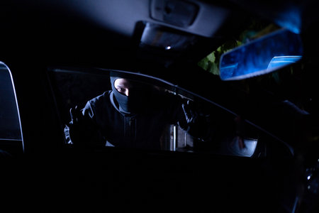 Robber looking thru car window. Car robbery concept