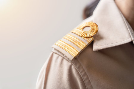 Photo of a brown uniform with a gold stripe on the shoulder, Thai civil servant uniform.の写真素材