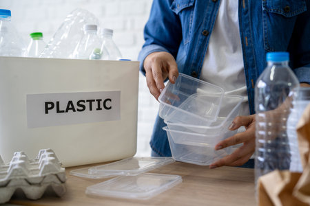 Waste disposal and recycling. Woman separates plastic waste for recycling.の写真素材