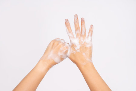 Woman using hand sanitizer to prevent spread of virus or bacteria isolated on white backgroundの写真素材