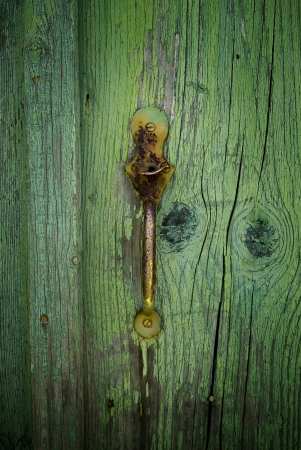A grunge old wooden weathered door with rusty metal handleの写真素材