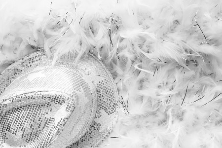 Black and white style party background with white sequins hat and feather boaの写真素材