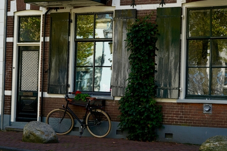 typical Dutch bike in front of some windows of a homeの写真素材