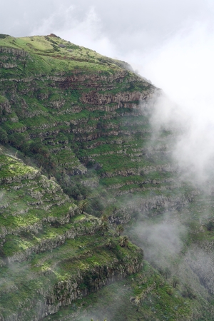green mountain of La Gomera, half in the sunshine, half in the cloudsの写真素材
