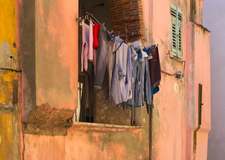 Closeup of laundry on a line in front of a homeの写真素材