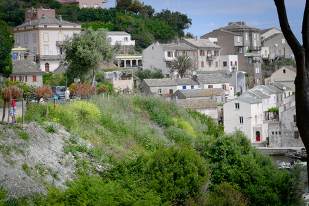homes of an old mountain village, some green in the foreground