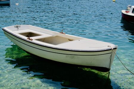 White rowing boat on the turquoise seaの写真素材