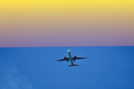 airplane in the air the sunsetの写真素材