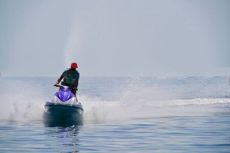 man driving with a jetski on the oceanの写真素材