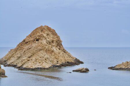 Close-up of a beige rock in the seaの写真素材