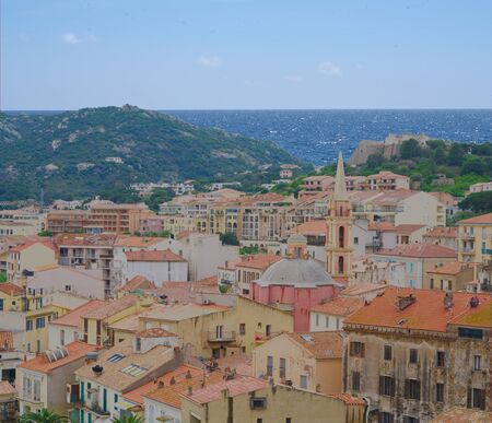 Close-up of a mountain village, the sea and a blue sky in the backgroundの写真素材