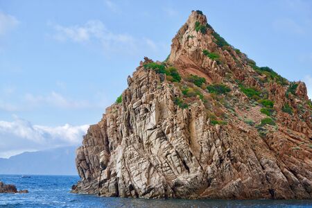 Close-up of a beige rock in the blue seaの写真素材