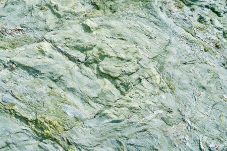 Green-turquoise rough stone backgroundの写真素材