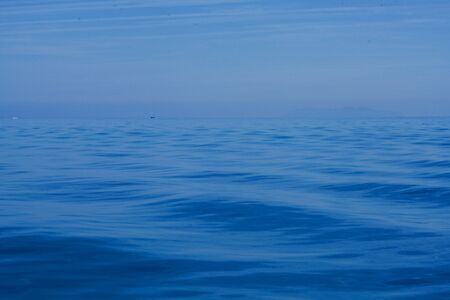 Blue sky over blue ocean - and two boats at the horzonの写真素材