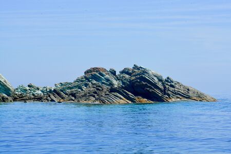 close-up of green-brown cliffs in the seaの写真素材