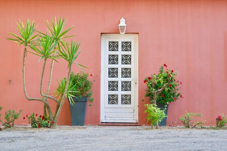 Close-up of a traditional French style door of a red decorated houseの写真素材