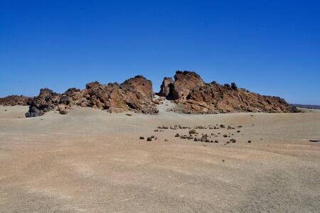 Rock formation at the beach under a perfect blue skyの写真素材