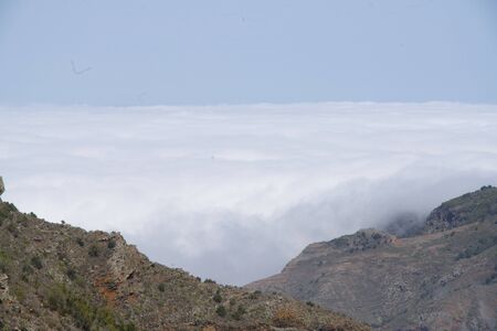 view through a mountain to the cloudscapeの写真素材