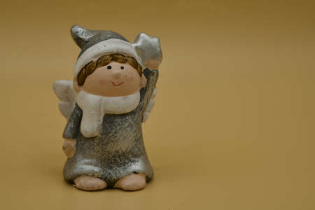 Isolated christmas angel in front of a beige backgroundの写真素材