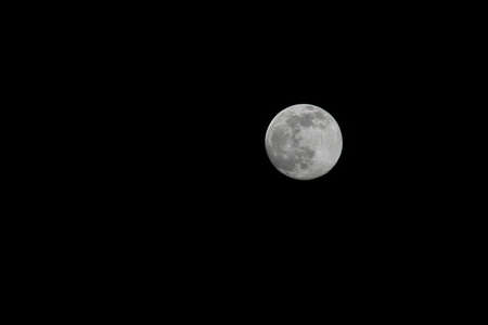 Background of a full moon with a black backgroundの写真素材