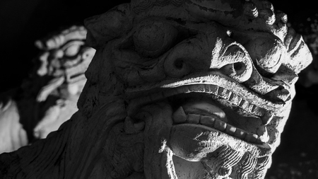 Black and white style image of   beautiful of lion stone chinese style  sculpture and thai art architecture in  in Wat Phra Chetupon Vimolmangklararm (Wat Pho) temple in Thailand.の写真素材