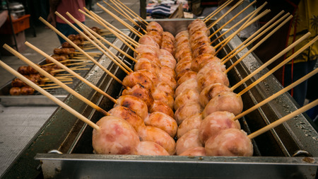 Vender selling sausage thai style local market at temple in Bangkok , Asia , Thailandの写真素材