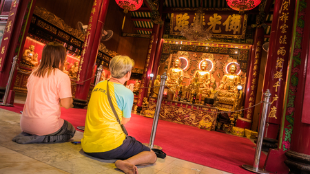 Bangkok, Thailand - September 9, 2016 : Unidentified people worship on Three Buddha gold statue chinese style in Wat Leng Nei Yee Chinese temple in Yaowarat road,Bangkok capital city,Thailand.のeditorial素材