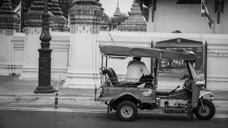 Bangkok, Thailand - SEPTEMBER 19, 2016 : Tuk Tuk taxi waiting customers on street at Wat Phra Chetupon Vimolmangklararm (Wat Pho) temple in Thailand/ Black and white style image ofのeditorial素材