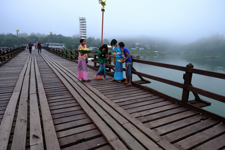 Kanchanaburi, Thailand - October 14, 2016: little Mon selling on the wooden bridge  (400 m. long made by hand), Sangkhaburi,Kanchaburi,Thailand.のeditorial素材