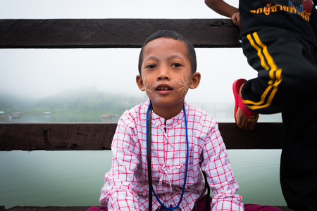 Kanchanaburi, Thailand - October 14, 2016: little Mon selling on the wooden bridge  (400 m. long made by hand), Sangkhaburi,Kanchaburi,Thailand.のeditorial素材