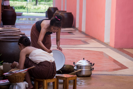 Kanchaburi, Thailand - November 12, 2016: Beautiful Thai women in Thai traditional style preparing cooking in thailand ancient simulation park kanchanaburi.のeditorial素材