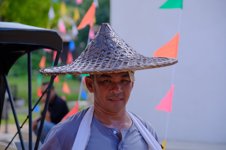 Kanchaburi, Thailand - November 12, 2016: Focus rickshaw driver Thai style  on the street in thailand ancient simulation park kanchanaburi. Photo taken on: 12 November 2016のeditorial素材