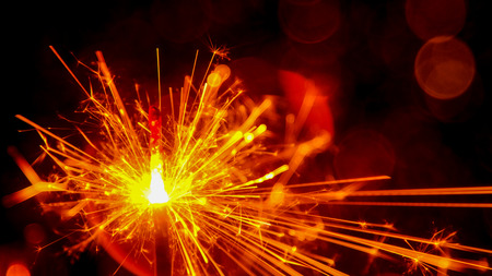 Christmas and New Year party sparkler with abstract circular bokeh background Christmas lights.