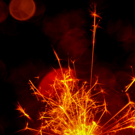 Christmas and New Year party sparkler with abstract circular bokeh background Christmas lights.