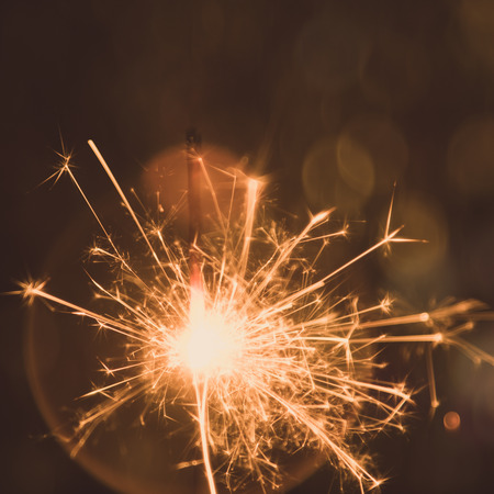 Christmas and New Year party sparkler with abstract circular bokeh background Christmas lights.