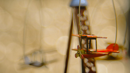 Vintage style. Toy plane with abstract circular bokeh background Christmas lights.