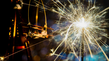Toy plane with New Year party sparkler and abstract circular bokeh background Christmas lights.の写真素材