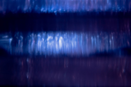 Blue bokeh background created by neon lights and under water.