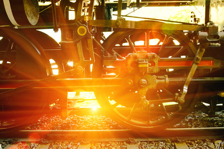 Closeup view of the old wheels of a railway wagon. Soft focus and lighting flare effectの写真素材
